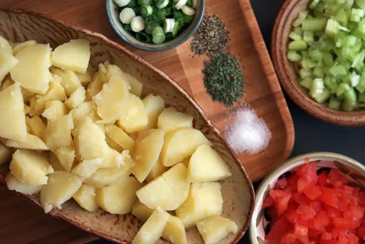 Fresh potato salad fixings with herbs and ingredients