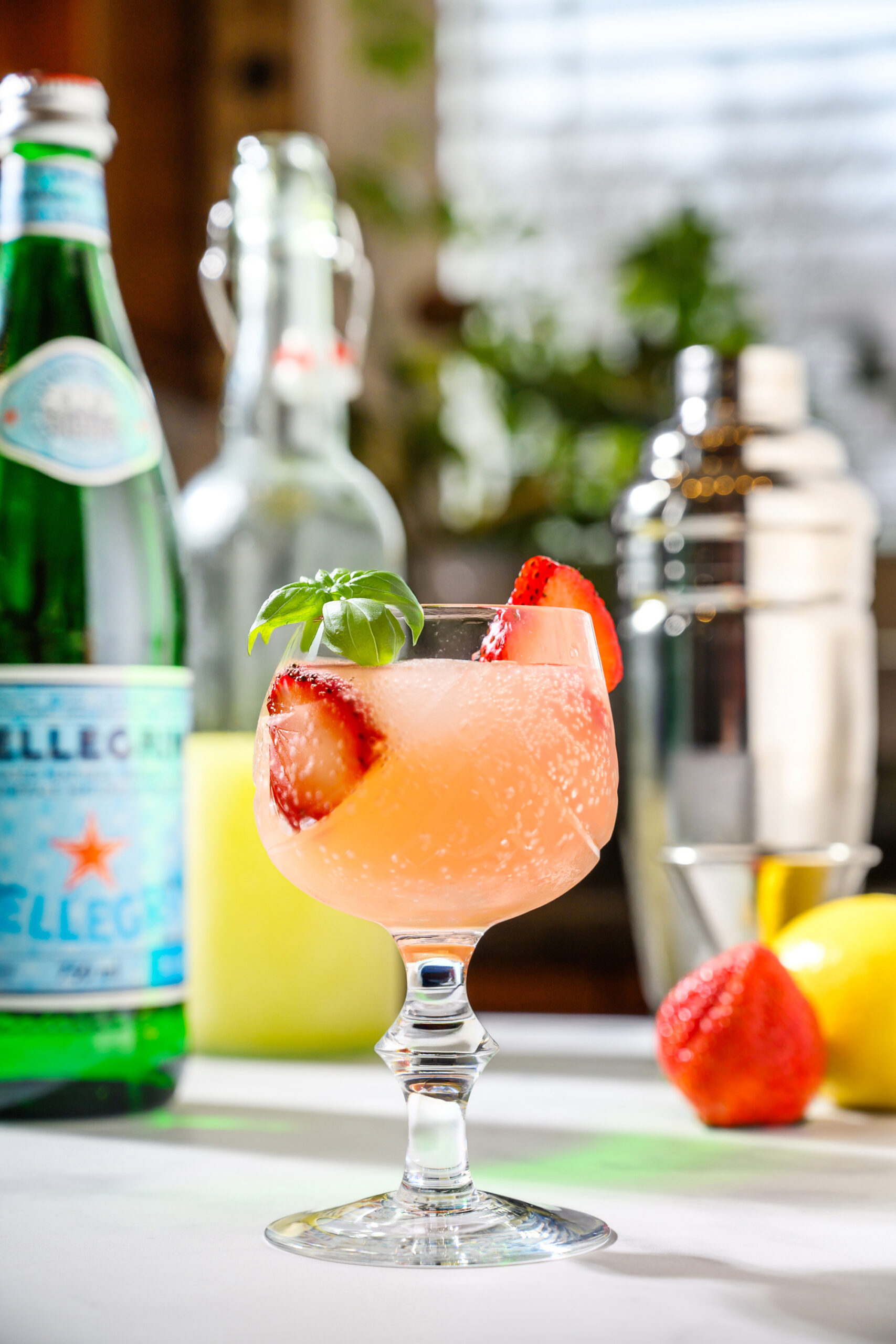 limoncello spritz with limoncello, san pellegrino, fresh strawberries, and strawberry basil simple syrup